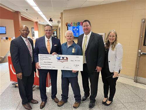 Gary Johnson with oversized check and prize patrol